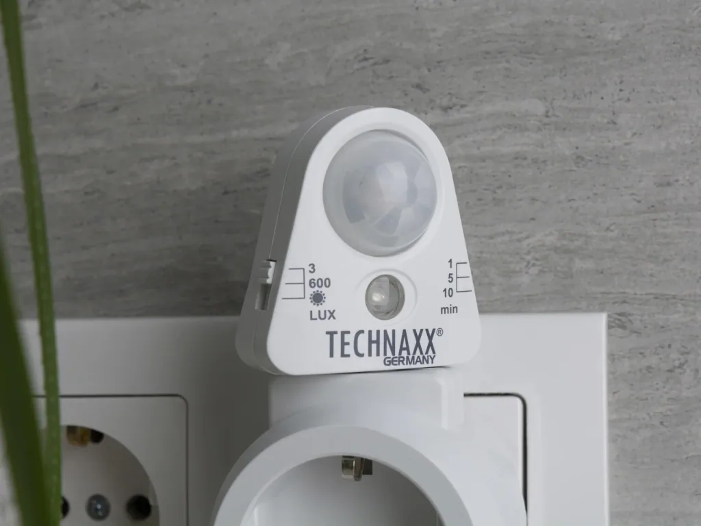 Socket adapter with motion detector and light sensor